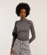 Blusa de manga larga confeccionada en poliamida con elastano, de diseño seamless sin costuras. Presenta cuello alto redondo y una textura sutil en toda la prenda.