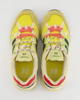Championes retro runner Coolway modelo 2003 Neon Pulse, con diseño multicolor que combina amarillo, verde lima, detalles en azul marino y acentos en rosa. Confeccionados con un mix de texturas que incluye malla y paneles superpuestos con refuerzos.