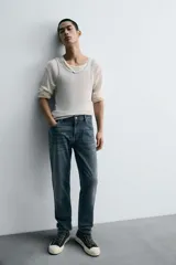 Pantalón de jean corte slim fit, color gris con efecto lavado. Presenta diseño de cinco bolsillos, cierre frontal con cremallera y botón, y tejido elástico.