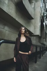 Blazer de corte sastre con cuello solapa, manga larga y hombreras marcadas. Presenta un diseño cruzado con cierre frontal de botones, bolsillos delanteros de vivo y abertura posterior en el bajo.