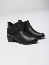 Bota tipo chelsea de caña baja, confeccionada en cuero con textura grabada efecto reptil en color marrón oscuro. Presenta paneles laterales elásticos en gamuza al tono y un taco cuadrado de altura media.