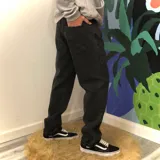 Pantalón de jean negro con corte holgado y tiro medio.