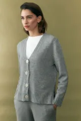 Cárdigan gris melange con cuello en V y cierre frontal con botones.