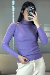 Buzo de hilo de punto acanalado en color lila, con cuello medio alto y mangas largas ajustadas.