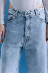 Jean de corte oversize y tiro medio-alto, en color celeste con lavado tipo ice y acabado con foil transparente. Presenta un diseño de pierna ancha y estampa en la parte trasera.