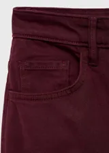 Jeans wide leg tiro alto color bordó, con cinco bolsillos, trabillas y cierre delantero de cremallera y botón.