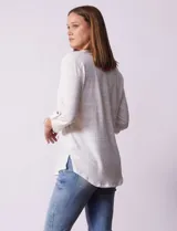 Blusa Ninety color beige con textura, cuello base con escote en V y abertura central con botones. Tiene un bolsillo en el pecho y mangas 3/4 regulables con presilla y botón.