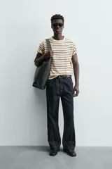 Camiseta color arena de algodón compacto, corte recto, cuello redondo y mangas cortas.