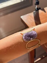 Brazalete rígido con diseño de espirales, hecho a mano en alpaca color plateado y amatista en bruto.