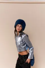 Chaqueta corta plateada con cierre frontal, cuello camisero y mangas largas.