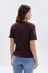 Remera de manga corta color marrón, con cuello redondo y estampa frontal con la inscripción 'NEW YORK' en letras blancas.