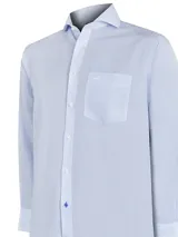 Camisa de vestir a rayas verticales celestes y blancas, de corte regular fit, con cuello italiano, bolsillo en el pecho con logo bordado y mangas largas con puños abotonados.