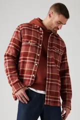 Camisa de franela a cuadros color ladrillo, con bolsillos frontales y corte recto.