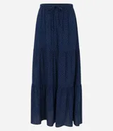 Pollera midi azul marino con estampado de lunares blancos, cintura elástica con lazo y volados.