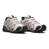 Championes de trail running Salomon Speedcross 3, color blanco marfil con detalles en rosa claro y negro, sistema de cordones Quicklace, suela Contagrip y amortiguación ligera.