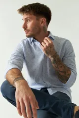 Camisa de manga larga color rosa claro con pequeños lunares azules, confeccionada en lino y algodón, de corte regular y logo bordado.