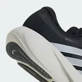 Championes de running Adidas Supernova Rise 3, color negro con las tres tiras laterales en blanco y mediasuela de amortiguación Dreamstrike+ en tono crema. Confeccionados con exterior de tela técnica Primeweave y suela de caucho Lighttraxion.