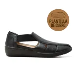 Zapato casual negro de cuero con plantilla de cuero, con perforaciones decorativas y elásticos laterales.