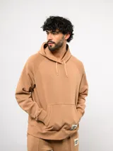 Canguro de felpa color verde menta, con capucha, bolsillo canguro frontal y etiqueta del logo Umbro en la parte delantera.