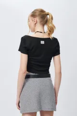 Top corto negro de escote cuadrado y manga corta con costuras tipo corsé.