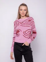 Sweater amarillo de tejido de punto con diseño de jacquard con ondas turquesas. Es de cuello redondo y manga larga.