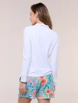Campera liviana blanca de silueta entallada con protección solar UPF 50, cuello alto y cierre frontal completo. Cuenta con mangas largas y bolsillos laterales.