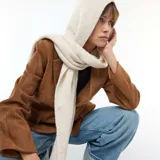 Bufanda de punto acanalado color beige con capucha integrada, diseñada para cubrir la cabeza y el cuello.