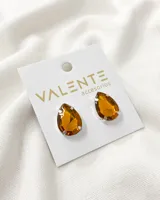 Par de aros Valente con forma de lágrima y cristal color ámbar.