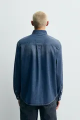 Camisa de corte regular fit confeccionada en tejido de mezcla de algodón y cashmere. Presenta cuello con botones, cierre frontal de botones, mangas largas con puños abotonados y un acabado con efecto lavado.