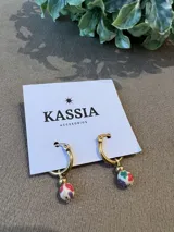 Aros de argolla dorada de acero quirúrgico con dije redondo de fimo blanco con flores de colores y bolita dorada.