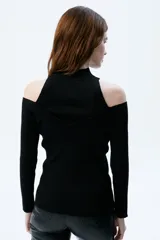 Top tejido de rib negro con aberturas en pecho y hombros, cuello alto, mangas largas y calce al cuerpo.