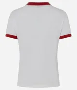 Remera de algodón blanca de corte ajustado, con cuello redondo y ribetes en las mangas de color rojo. Cuenta con un estampado frontal localizado del logo de Supergirl.