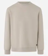 Buzo deportivo color verde claro, de manga larga y cuello redondo. Confeccionado en tejido de poliéster, viscosa y elastano.