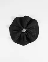 Gomita de pelo grande tipo scrunchie, color beige, confeccionada en poliéster y elastano.