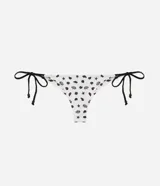 Bombacha de bikini de microfibra color blanco con estampado de caracoles y estrellas de mar en negro, con laterales regulables mediante lazos negros.