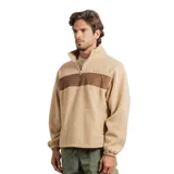 Buzo de polar tipo sherpa en color beige, con cierre frontal parcial y una franja horizontal de color marrón en el pecho. Presenta cuello alto, mangas largas con puños elásticos y un diseño holgado.