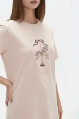 Remera de algodón blanca, de corte holgado, con cuello redondo y diseño estampado en el centro que incluye un gato comiendo de un plato y la inscripción 'Wild Cats'.