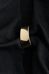 Malla enteriza de color negro con escote en V, tirantes ajustables y copas con relleno extraíble. Cuenta con diseño cut-out frontal decorado con herrajes metálicos dorados, corte de pierna alto y espalda de cobertura media.