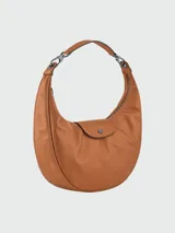 Cartera hobo Longchamp modelo Le Pliage Xtra, de cuero color tostado con diseño curvado, asa de hombro y solapa frontal con cierre de botón a presión.