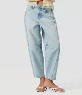 Pantalón de jean con corte balloon, tiro alto y lavado claro, confeccionado en algodón. Presenta piernas amplias con ruedo levemente entallado, bolsillos delanteros y traseros, pasadores para cinturón y cierre frontal con botón y cremallera.