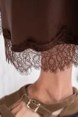 Falda midi negra de acabado satinado, corte al bies, con detalle de encaje en el ruedo.