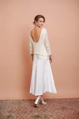 Blusa blanca con bordado de mostacillas y lentejuelas, escote redondo y manga larga.