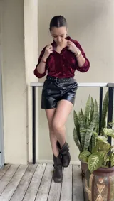 Buzo negro de terciopelo con escote en V y bolsillos frontales.