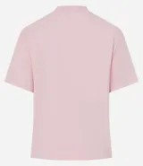 Remera blanca de algodón con cuello redondo y corte boxy, con apliques de flores de tejido en relieve en la zona del pecho.