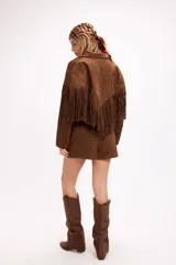 Bota estilo western de caña alta con efecto slouchy, confeccionada en símil gamuza color negro, con punta afinada y suela plana.