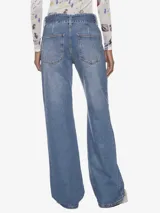 Pantalón jean celeste de corte ancho, con cinturón ancho integrado con hebilla metálica.