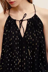 Top halter negro con detalles metalizados dorados, escote fruncido con tirantes finos y lazo ajustable al frente.