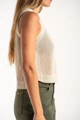 Chaleco tejido sin mangas de calce al cuerpo, con cuello redondo y diseño de punto abierto. Presenta terminaciones acanaladas en cuello, sisas y ruedo.