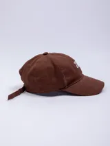 Gorro marrón de gabardina con visera y bordado frontal con la frase "You are Good" en color blanco.