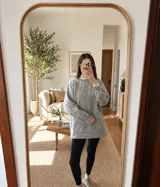 Buzo gris de calce oversize con cuello redondo y mangas largas. Presenta el logo de la marca bordado en el frente y un parche con la bandera de Uruguay en la manga izquierda.